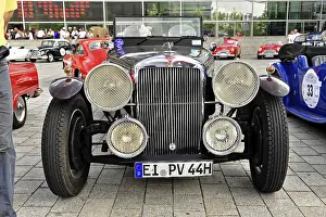 Front view of a vintage car with large headlights and stylish bumper