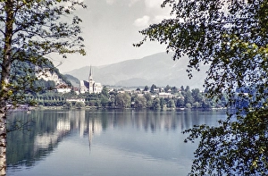 View over water of to church of Saint Martin and town, Lake Bled, Bled, Slovenia, former Yugoslavia, Europe 1959, Europe