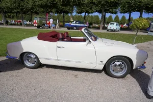 Side view of a white convertible at a motor show