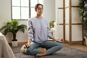 Front view young woman meditating home