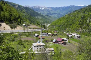 Framed Print : Village with a mosque in a green valley surrounded by mountains