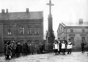 Village square with priest and altar boy ca