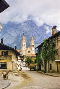 Village street with historic buildings leading to the parish church, Telfs, Tyrol, Austria, Europe 1950s, Europe
