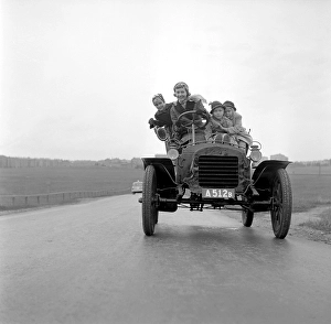 The vintage car 1955. The mother and her three children are seen in an old vintage car looking happy