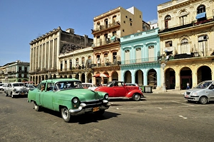 Vintage car in front of buildings with colourful facades