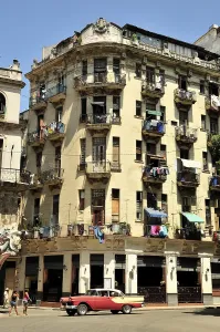 Vintage car in front of buildings with colourful facades