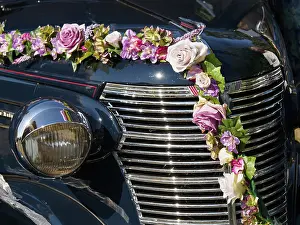 Vintage car with flowery decoration and shiny chrome grille