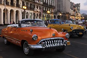Vintage cars on the Prado at dusk