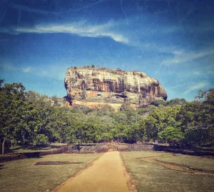 Vintage retro hipster style travel image of famous ancient Sigiriya rock with grunge texture overlaid