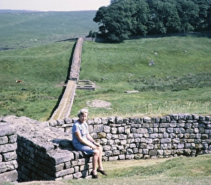 Visit to the Archaeological Society at Hadrian's Wall, Northumberland, England, UK View to the east Housesteads Roman fort north-west corner with seated woman, 3rd century cattle gate