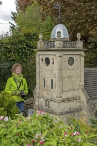 Visitor looking at church tower at miniature village
