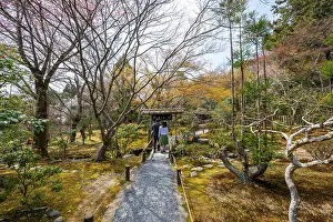 Visitors on a path in the Japanese garden of Ryoan-ji Temple
