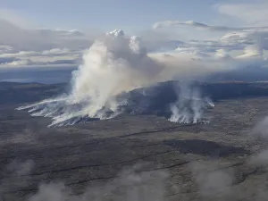 Volcanic eruption, smoke plumes and lava field