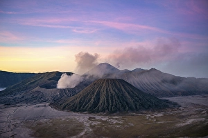 Volcanic landscape at sunrise, smoking volcano Gunung Bromo