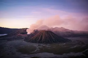 Volcanic landscape at sunrise, smoking volcano Gunung Bromo