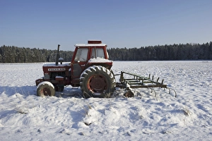 Category Scandinavia Prints: Volvo BM 700 tractor and spring tooth harrow covered with snow