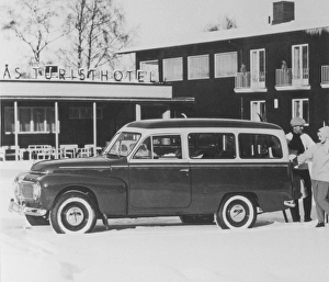 Volvo Duett. A Volvo Duett is parked outside a winter resort hotel. The design of the automobile is based on the Volvo PV sedan and shares its engine and front suspension with that model. The Duett was in production between 1953-1969