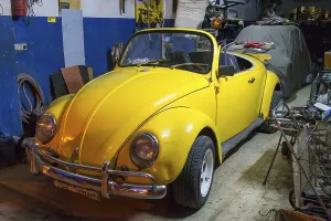 VW Beetle Cabrio, yellow, in a garage