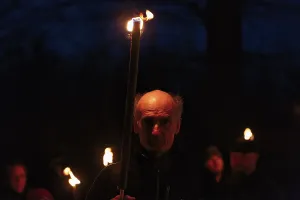 Walkers with torches at night, torchlight walk in winter
