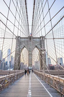 Walking in the evening light over the Brooklyn Bridge
