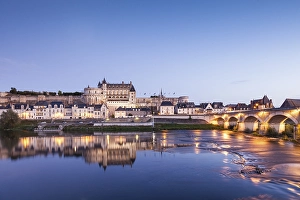 The walled town and Chateau of Amboise reflected in the River Loire in the evening
