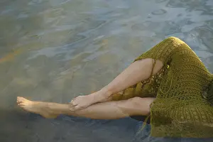 On a warm day, a person relaxes by the lake