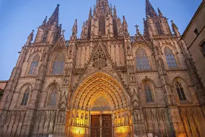 Warm lights illuminating the ornate facade of barcelona cathedral in the gothic quarter at dusk