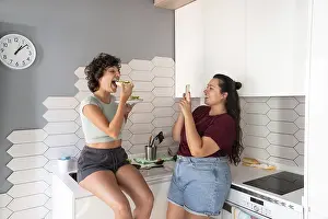 A warm scene of a lesbian couple in a kitchen