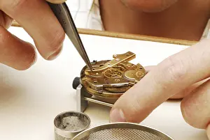 Watchmaker cleaning a pocket watch