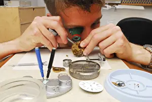 Watchmaker cleaning a pocket watch