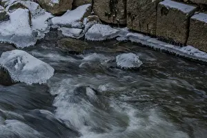 The water flows quickly over the stones