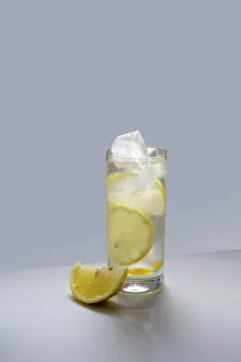Water with lemon and ice cubes in a glass