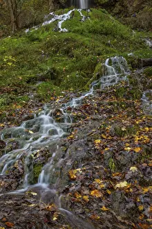 Waterfall in autumn in the middle of the forest