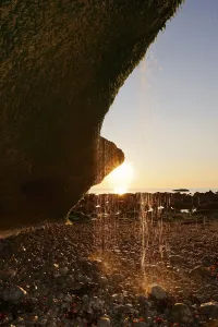Waterfall on the cliffs backlit at sunset