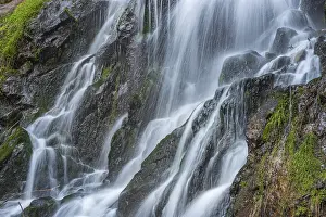 Waterfall on a mountain stream in spring