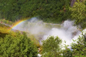 Waterfall and rainbow on the way to Briksdal or Briksdalsbreen glacier in Olden
