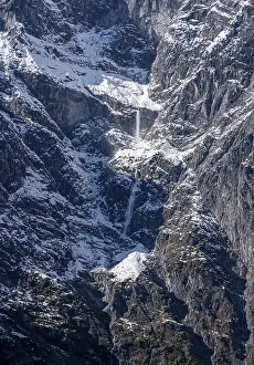 Waterfall of snow on a rock face