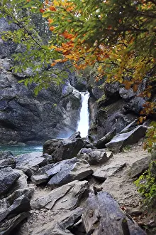 Waterfall surrounded by rocks and autumn trees