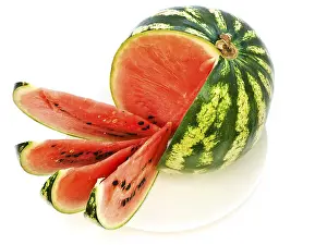 Watermelon With Slices At Plate Against The White Background Daugavpils