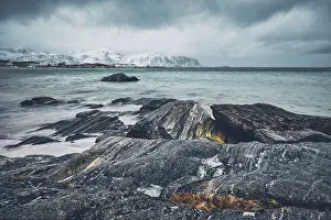 Waves of Norwegian sea on rocky beach of fjord