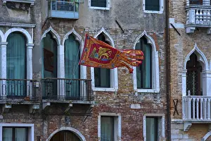 Waving flag of the Republic of Venice on a palace