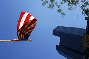 Waving US flags backlit with skyscraper