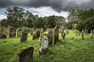 Weathered gravestones in the old graveyard of the monastic ruins of Lanercost Priory