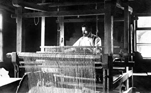 Weaving mill, man at the loom, 1910s