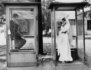 Wedding couple in a public telephone booth