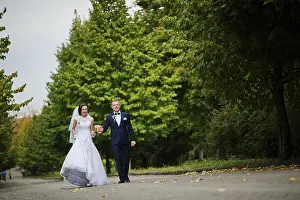 Wedding couple walking at green park