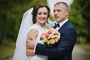 Wedding couple walking at green park