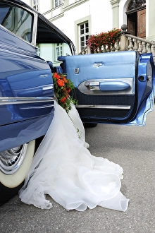 Wedding dress hanging out of a 1959 Chevrolet