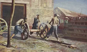 Wheelwright at work, wooden cartwheels are tyred with iron