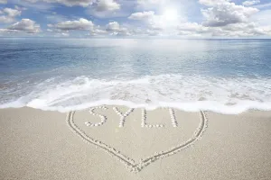 White beach with a heart made of shells